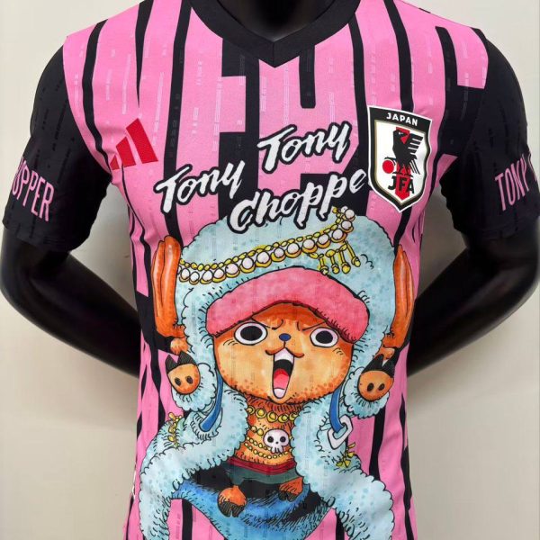 Bright pink and black striped jersey with a large Tony Tony Chopper cartoon and the Japan Football Association patch at chest level.