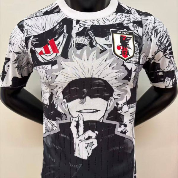 Black-and-white manga-print T-shirt on a mannequin, featuring a character with a blindfold and white hair, and a Japan JFA crest on the chest.