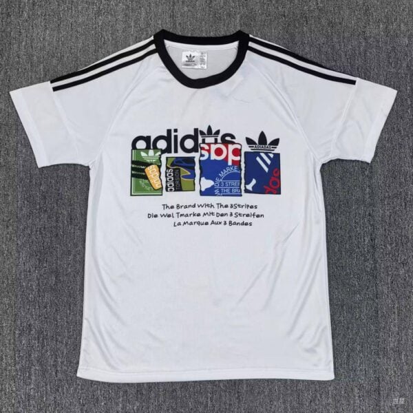 White Adidas t-shirt with black stripes on the shoulders and a multicolor logo collage across the chest.
