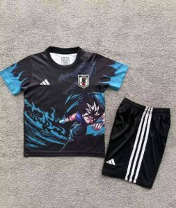 Youth black soccer jersey with anime print and Japan crest, paired with black shorts with white Adidas stripes