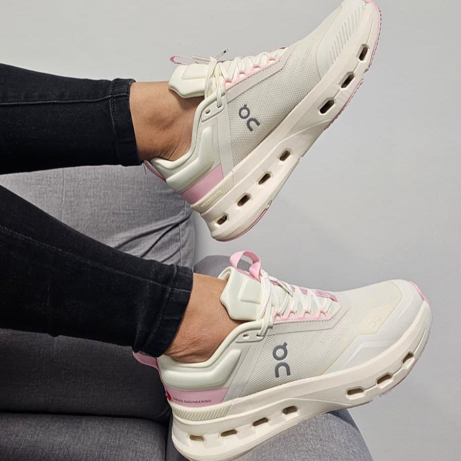 541838582_17942130906050663_1794100697115693400_n | UAE SPORT STORE Cream running sneakers with pink laces and heel accents, On logo visible.