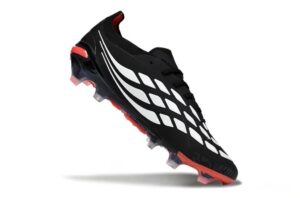 54ced8d2-4259-406a-a857-dc30c9089aaf | UAE SPORT STORE Black soccer cleat with white diamond pattern and red outsole, angled as if midair.