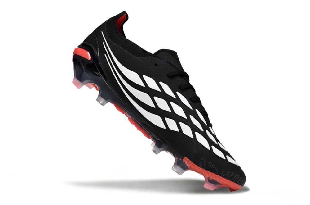 54ced8d2-4259-406a-a857-dc30c9089aaf | UAE SPORT STORE Black soccer cleat with white diamond pattern and red outsole, angled as if midair.