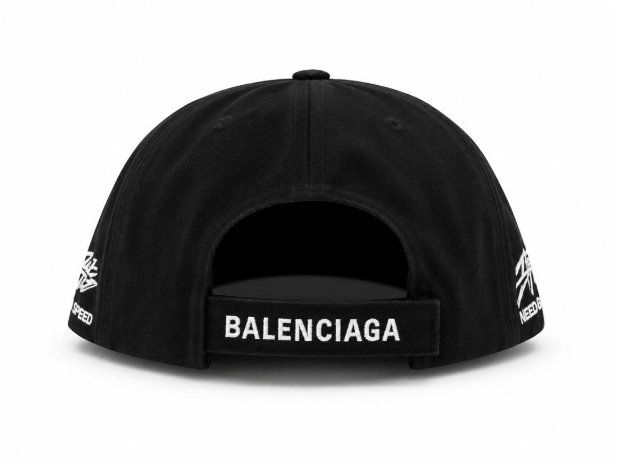 Back view of a black Balenciaga baseball cap with an adjustable strap reading BALENCIAGA