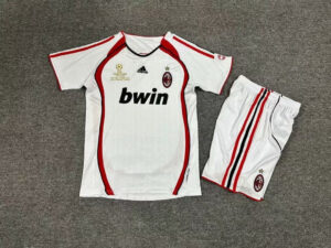 AC Milan white soccer kit with red trim, sponsor 'bwin' on the chest, crest and Champions League patch visible, paired with white shorts featuring red and black stripes.