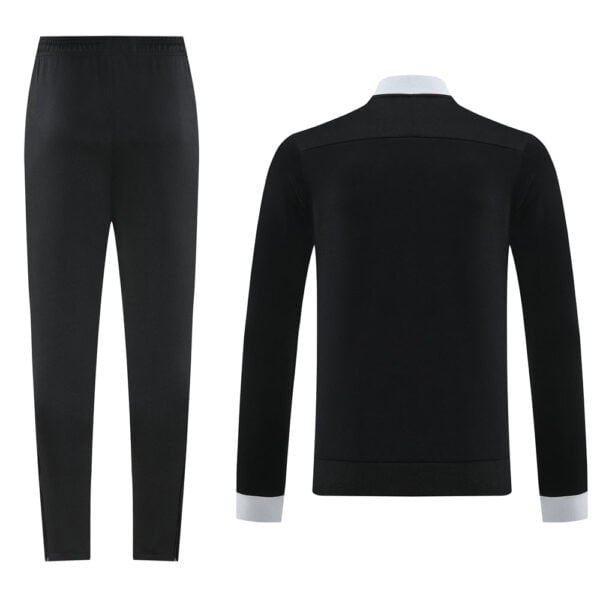 Black formal suit set with matching trousers and a tailored blazer featuring light gray cuffs and collar edges