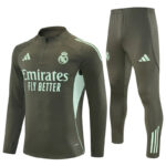 Real Madrid training tracksuit in dark green with mint accents and 'Emirates Fly Better' branding on the top.