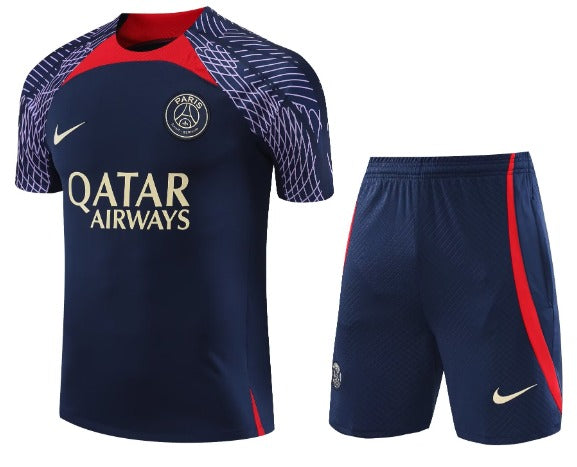 Paris Saint‑Germain navy football jersey and shorts with red accents, prominent Qatar Airways sponsor and Nike logo.