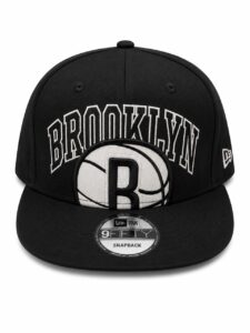 Black snapback cap featuring 'BROOKLYN' embroidery across the front and a basketball patch with a bold 'B' logo, New Era 9FIFTY label visible on brim edge, snapback closure likely behind.