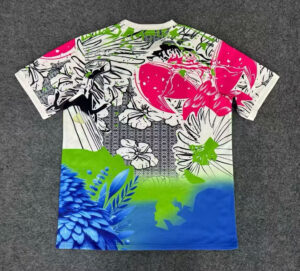 Bright, oversized T-shirt laid flat with abstract floral print in pink, blue, green on a white background.