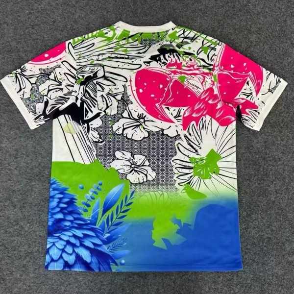 Bright, oversized T-shirt laid flat with abstract floral print in pink, blue, green on a white background.