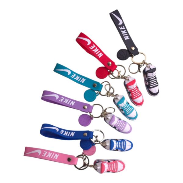 Multiple colorful Nike sneaker keychains attached to colored lanyards on a white background.