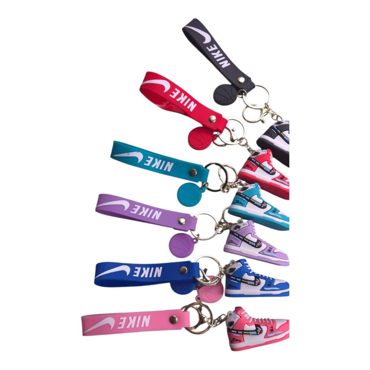 Set of Nike keychains with miniature sneakers and basketball charms on colorful lanyards in pink, blue, purple, and red.