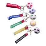 Set of five soccer-themed keychains with mini soccer balls attached to colored straps reading 'FIFA WORLD CUP' on each strap.