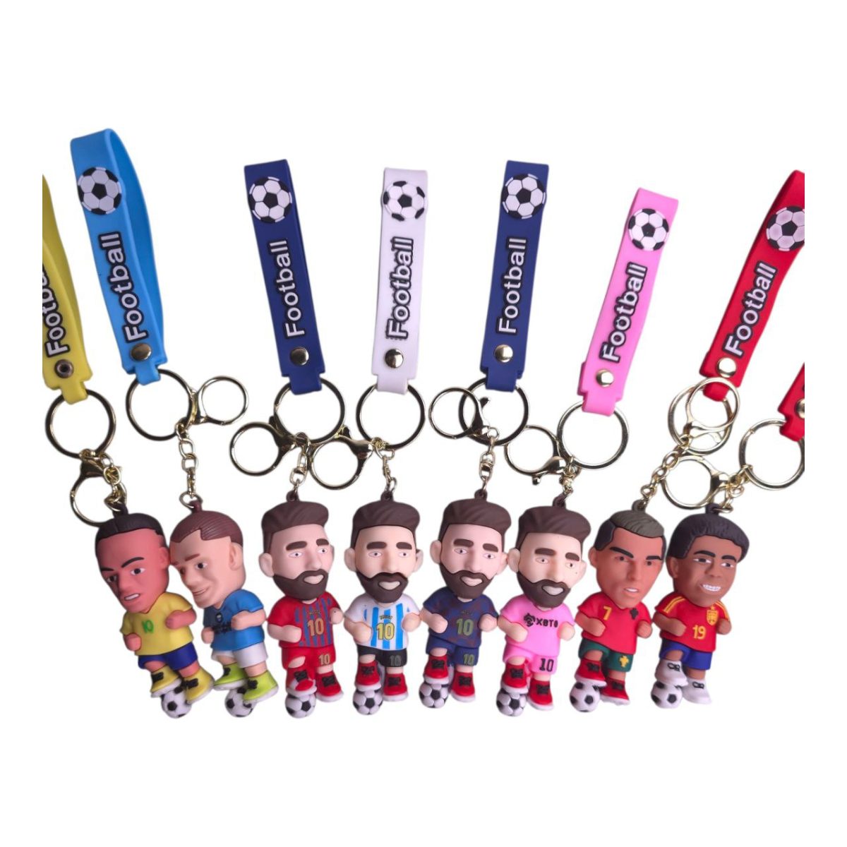 Assorted soccer player keychains with colorful straps and small soccer-ball figurines at the feet.