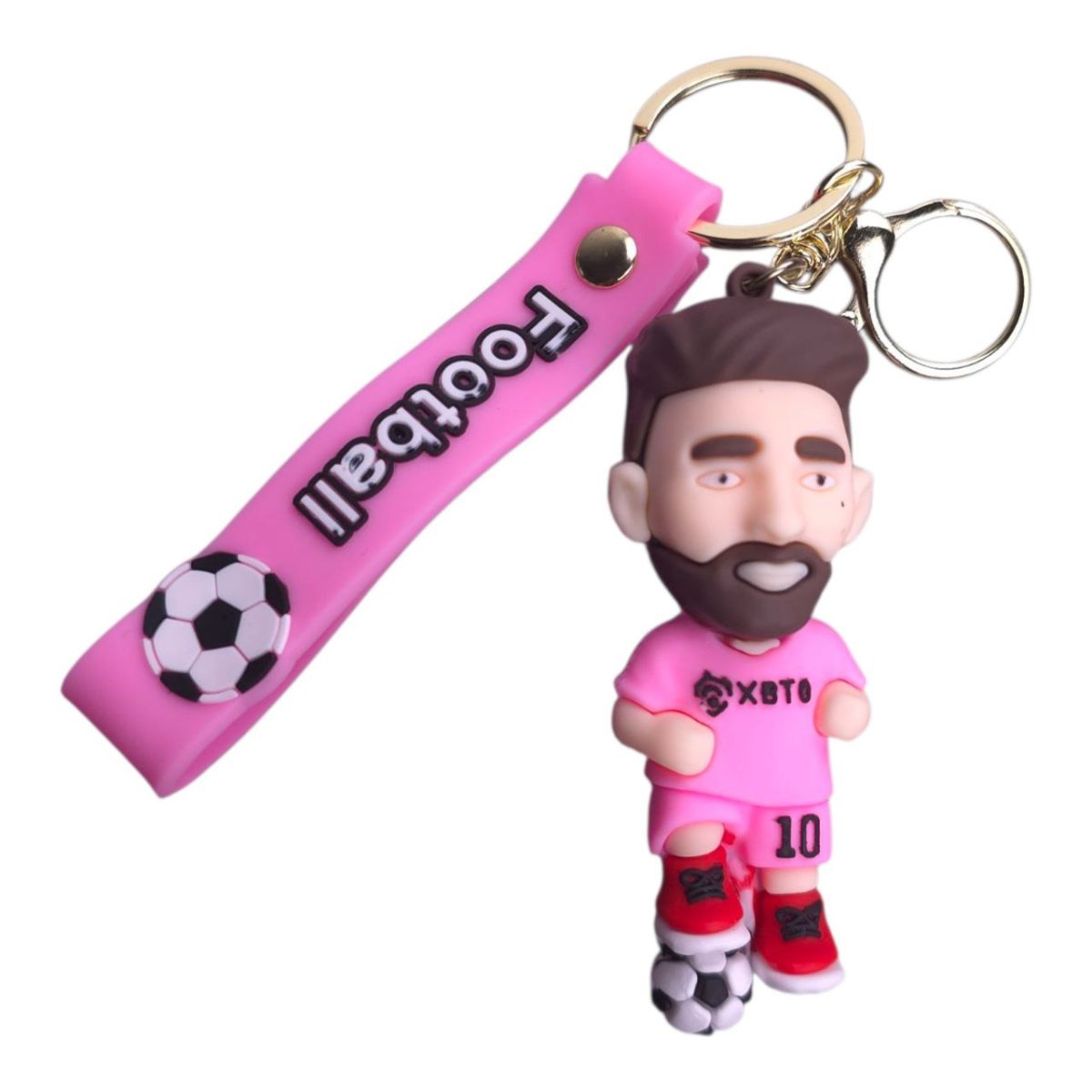 Pink keychain featuring a cartoon man in a pink soccer kit with a black beard, standing on a soccer ball, attached to a pink strap with football lettering for a fun sports keepsake