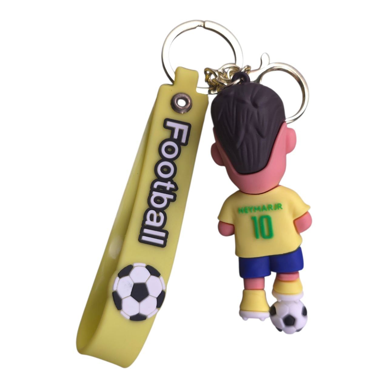 5805548633519671605 | UAE SPORT STORE Yellow strap keychain with 'Football' text and a small cartoon soccer player charm wearing a yellow shirt and blue shorts, standing next to a soccer ball