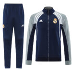 5814a274 | UAE SPORT STORE Real Madrid navy tracksuit: zip jacket with white stripes and crest, plus matching navy pants with crest.