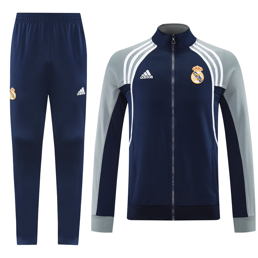 5814a274 | UAE SPORT STORE Real Madrid navy tracksuit: zip jacket with white stripes and crest, plus matching navy pants with crest.