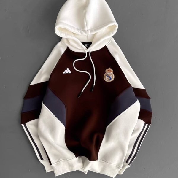 Real Madrid Adidas hoodie with white sleeves and hood, burgundy chest with navy panels, crest on the left chest, white drawstrings.