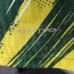 Close-up of yellow and green diagonal striped safety tape with a textured fabric surface.