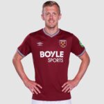 Male model wearing a maroon West Ham United football jersey with Boyle Sports sponsor, standing with hands on hips against a light background.