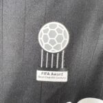590d6936_1d3aded8-0b9d-4ea9-b2b6-6c8cc6dac2fd | UAE SPORT STORE Metallic FIFA Award medal with a hexagonal soccer-ball pattern and hanging ribbons; inscription reads 'FIFA Award Best Club XX Century' (text partially visible).