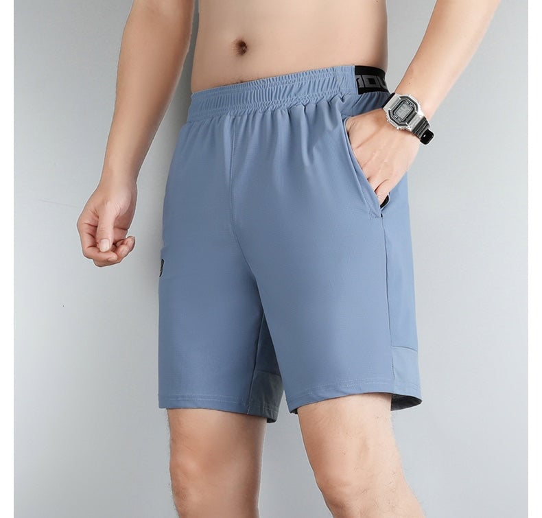 593f8306 | UAE SPORT STORE Light blue athletic shorts on a man, elastic waistband, side pocket, and a silver digital watch visible on his left wrist (mid-them length).