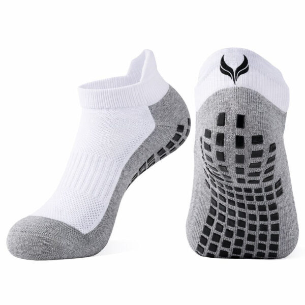 White and gray athletic socks with a grip-patterned sole and a black logo on the heel area, shown from the side and bottom for product detail