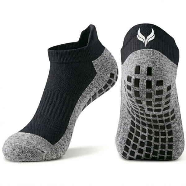 Pair of black and gray athletic socks with a textured knit and grippy, grid-like sole patterns on the bottom edge.