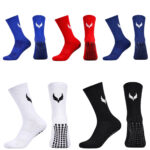 5967537890642300092 | UAE SPORT STORE Assorted athletic socks in blue, red, white, and black with grippy dotted soles and a white logo on the side.