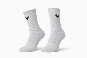 5969789690455985446 | UAE SPORT STORE Pair of light gray ribbed socks with a small black emblem near the top, displayed side by side on a white background.