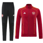 Arsenal training tracksuit: maroon zip jacket with yellow piping and crest, paired with black jogger pants bearing the club badge and Adidas logo.