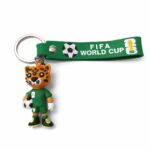 Green FIFA World Cup lanyard with a tiger mascot figurine holding a soccer ball