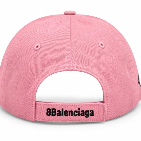 Back view of a pink baseball cap with an adjustable strap embroidered with '8Balenciaga' before the opening.