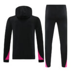 Back view of a black hoodie and matching track pants with pink panels at the cuffs and ankles.