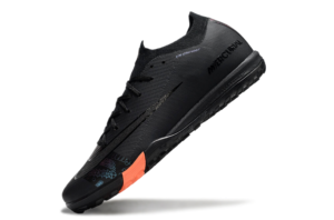 5b482734 | UAE SPORT STORE Black Nike Mercurial running shoe with an orange heel accent, shown at a diagonal angle for product display.