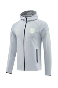 Light gray lightweight zip-up jacket with hood, FC Barcelona crest on chest, and Nike swoosh on the other side; front zip pocket on the left side