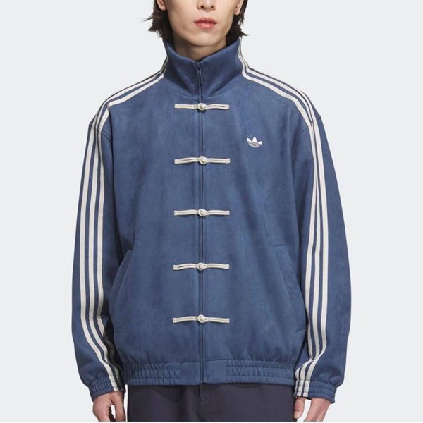 Man wearing a blue Adidas track jacket with white stripes along the sleeves and toggle closures on the front.