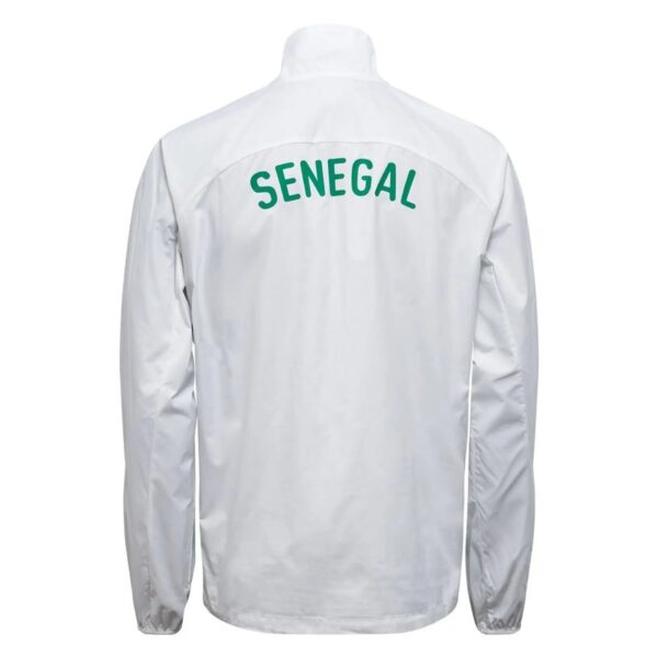 Back view of a white jacket with green curved text 'SENEGAL' across the upper back. Readable on a clean white garment.