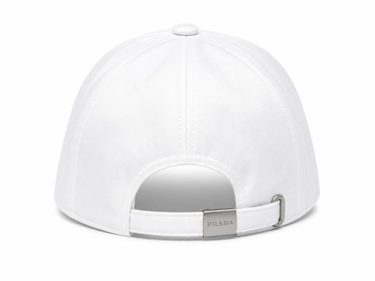 White baseball cap viewed from the back with an adjustable strap and metal clasp, showcasing the Prada logo on the clasp.