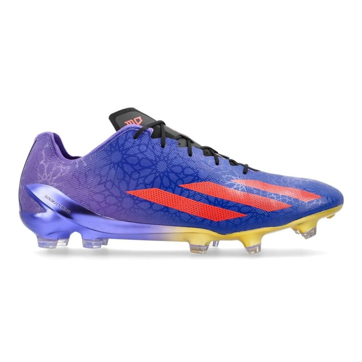 Purple and blue soccer cleat with orange stripes, showing laces and studded sole on a white background