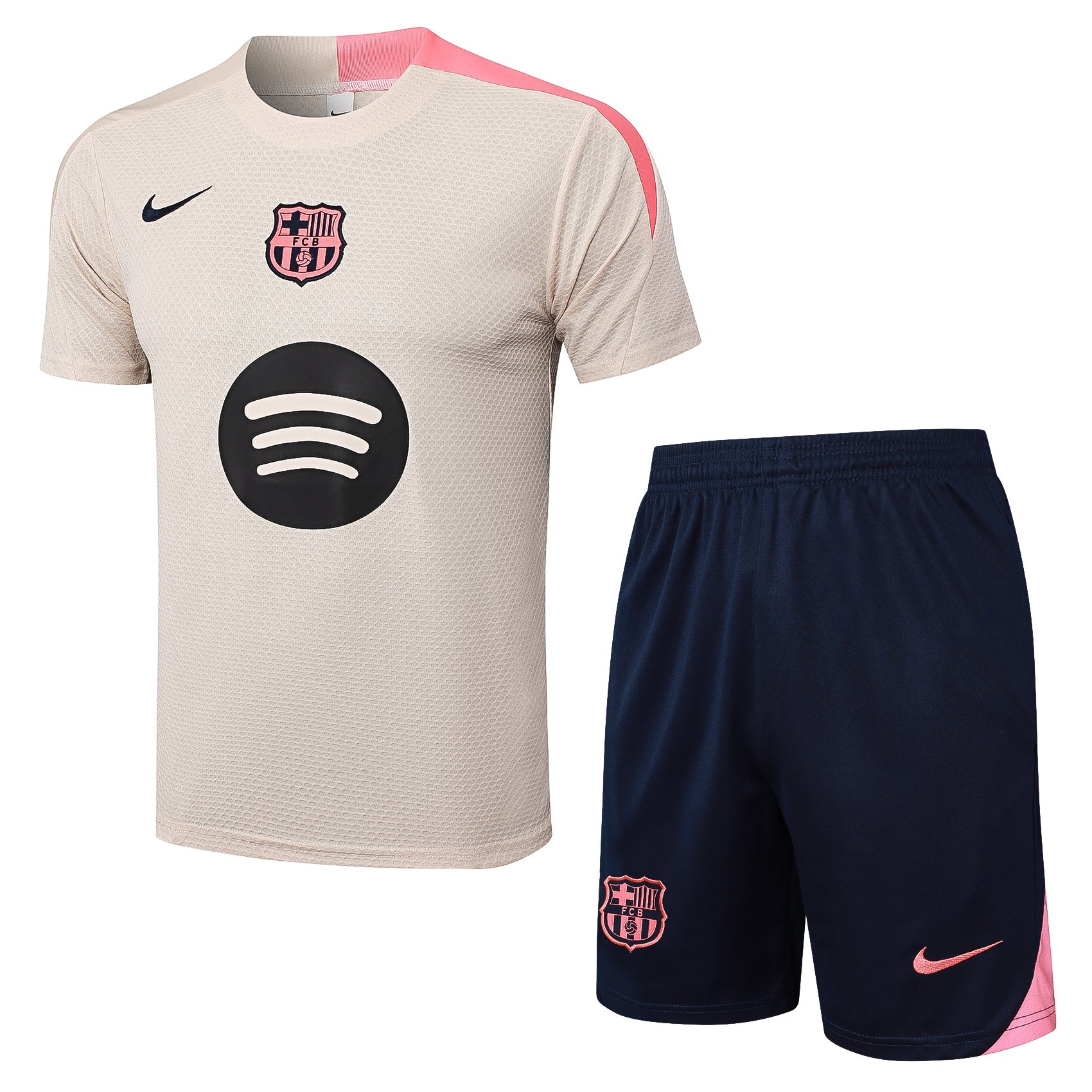 5d484f63 | UAE SPORT STORE Beige FC Barcelona soccer jersey with pink shoulder detail and navy Nike swoosh, large circular sponsor logo, paired with navy shorts featuring the pink Barça crest.