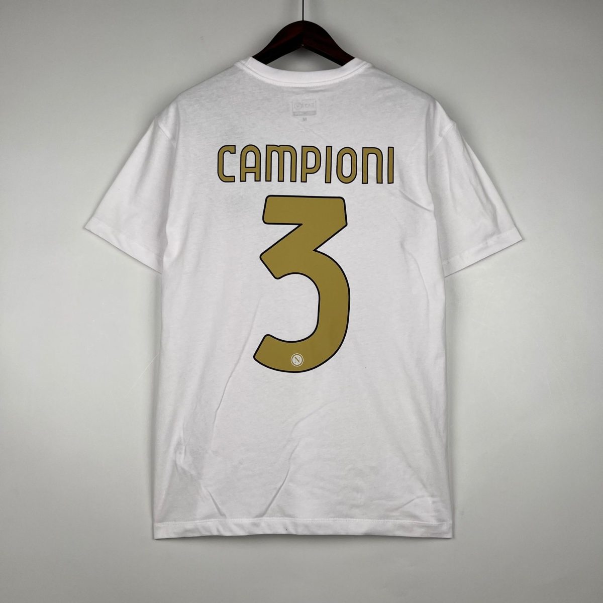 White T-shirt on a hanger with 'CAMPIONI' lettering visible on the back and a large gold number 3 below.