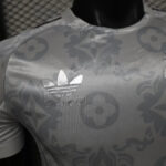 Close-up of light-patterned fabric with a Louis Vuitton logo and monogram pattern visible on the chest area.