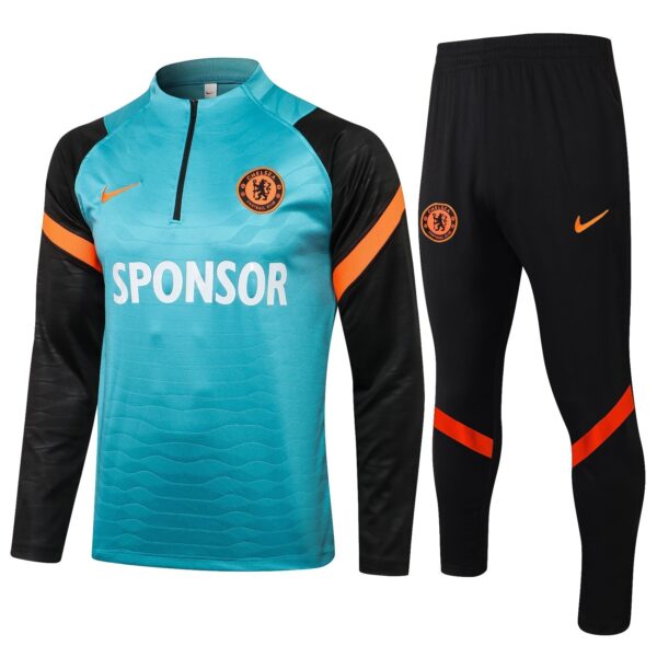 Chelsea FC goalkeeper kit: turquoise jersey with black sleeves, orange accents, sponsor text, and crest, plus black pants with orange stripes and crest.