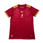 5e5fc394 | UAE SPORT STORE Red Adidas Mexico football jersey with gold crest and stripes, decorative gold pattern on sleeves and chest, and Aeroready marking near the hem.