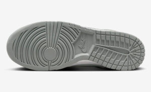 Bottom view of a gray Nike sneaker sole with concentric circular grip pattern and multiple tread grooves.