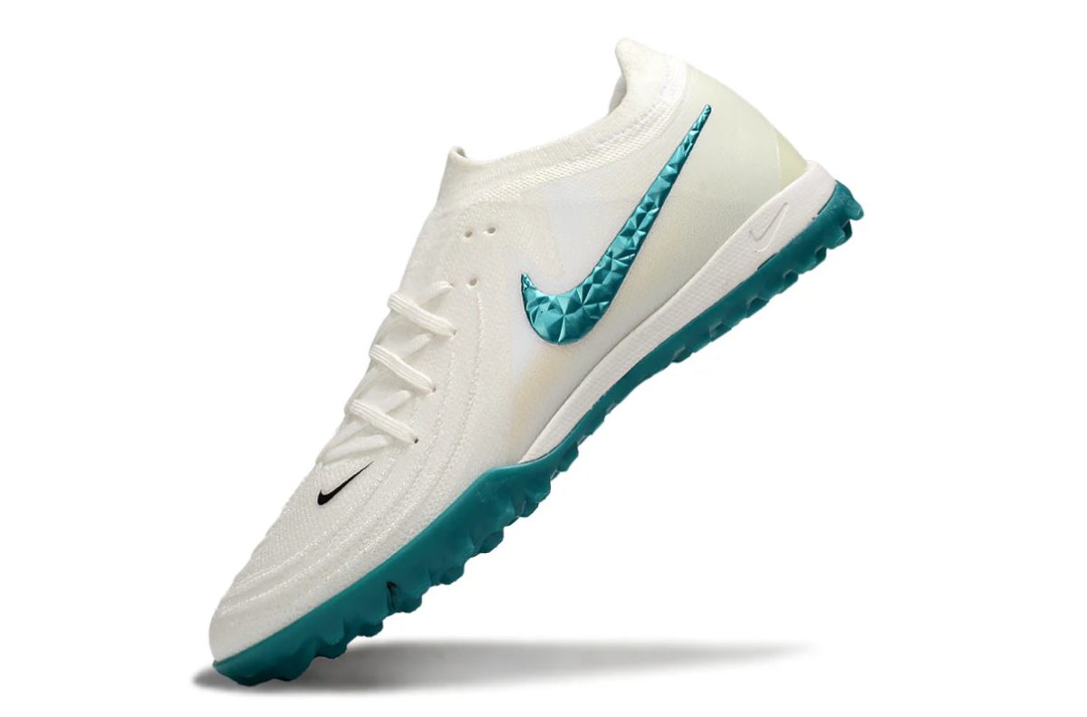 White Nike running shoe with teal studded swoosh and teal outsole, angled diagonally down-left.