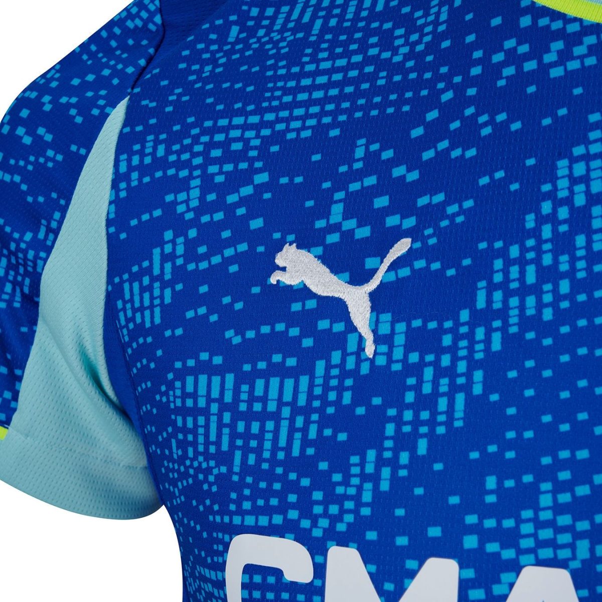 Close-up of a blue sports jersey with a white Puma logo and a pixelated light-blue pattern across the chest area.